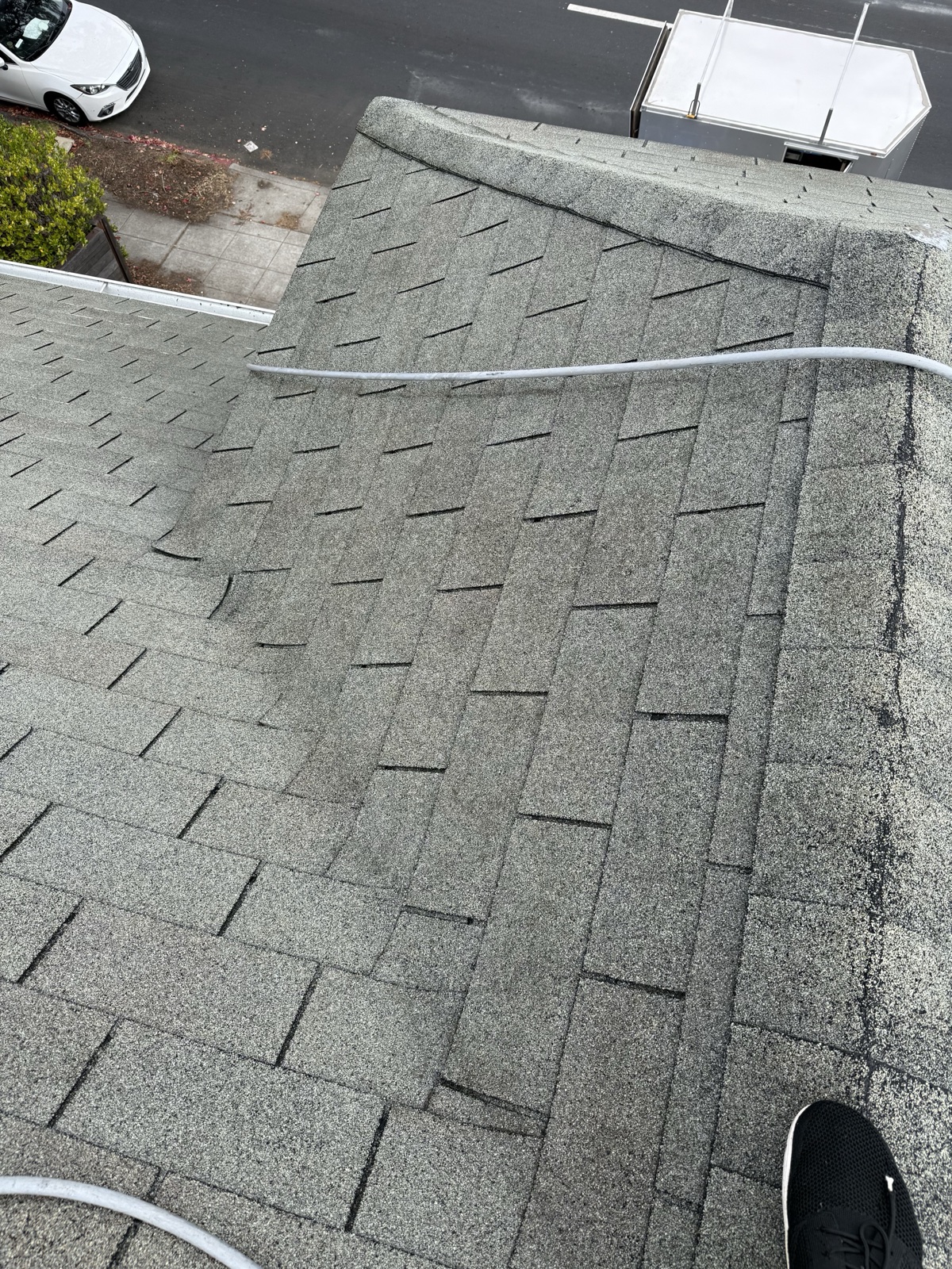 After — Berkeley shingle roof washed clean, hip and ridge lines light gray again above the street