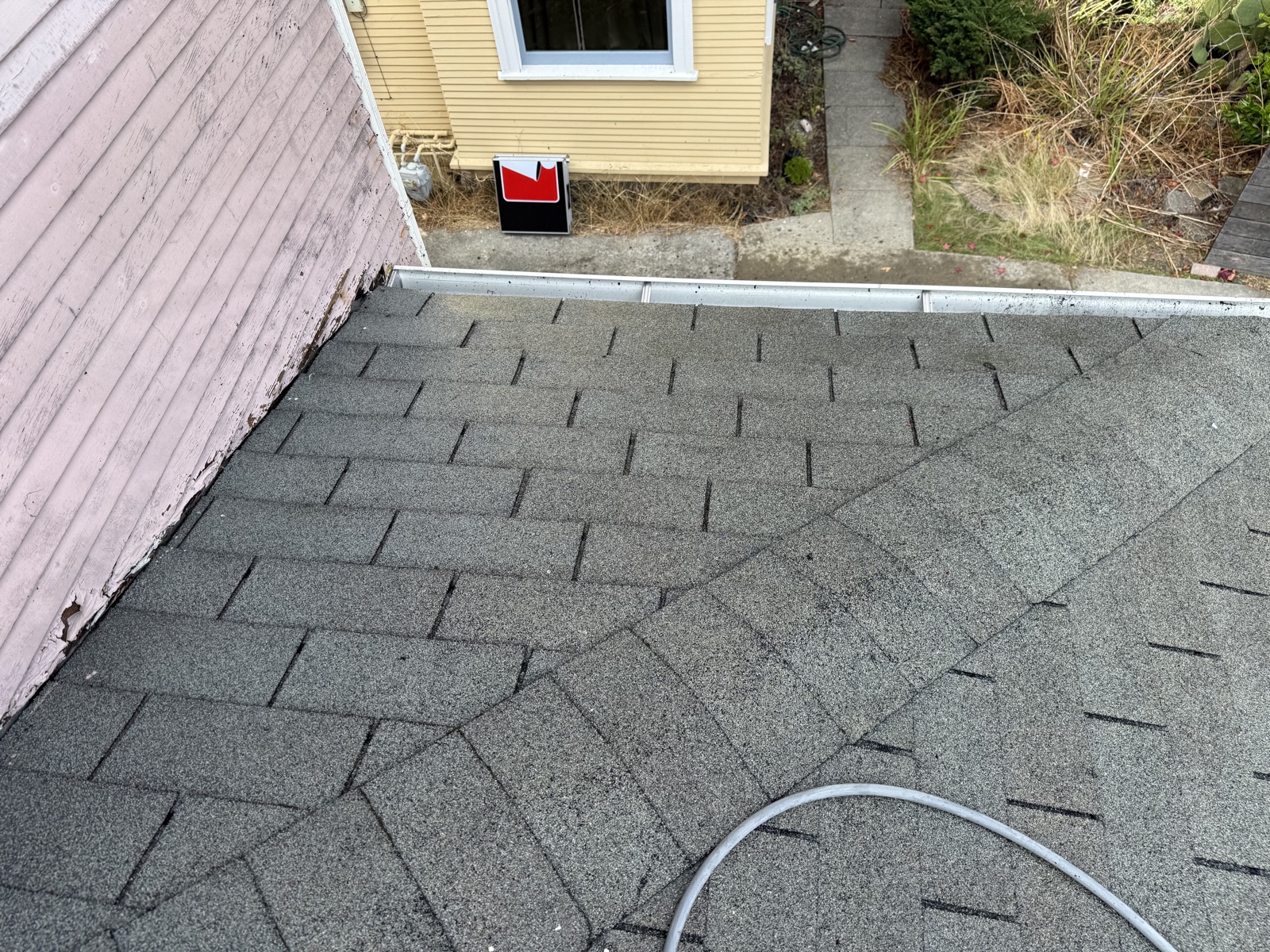 After — clean roof valley and gutter edge on a Berkeley home, moss cleared from the shingle keyways