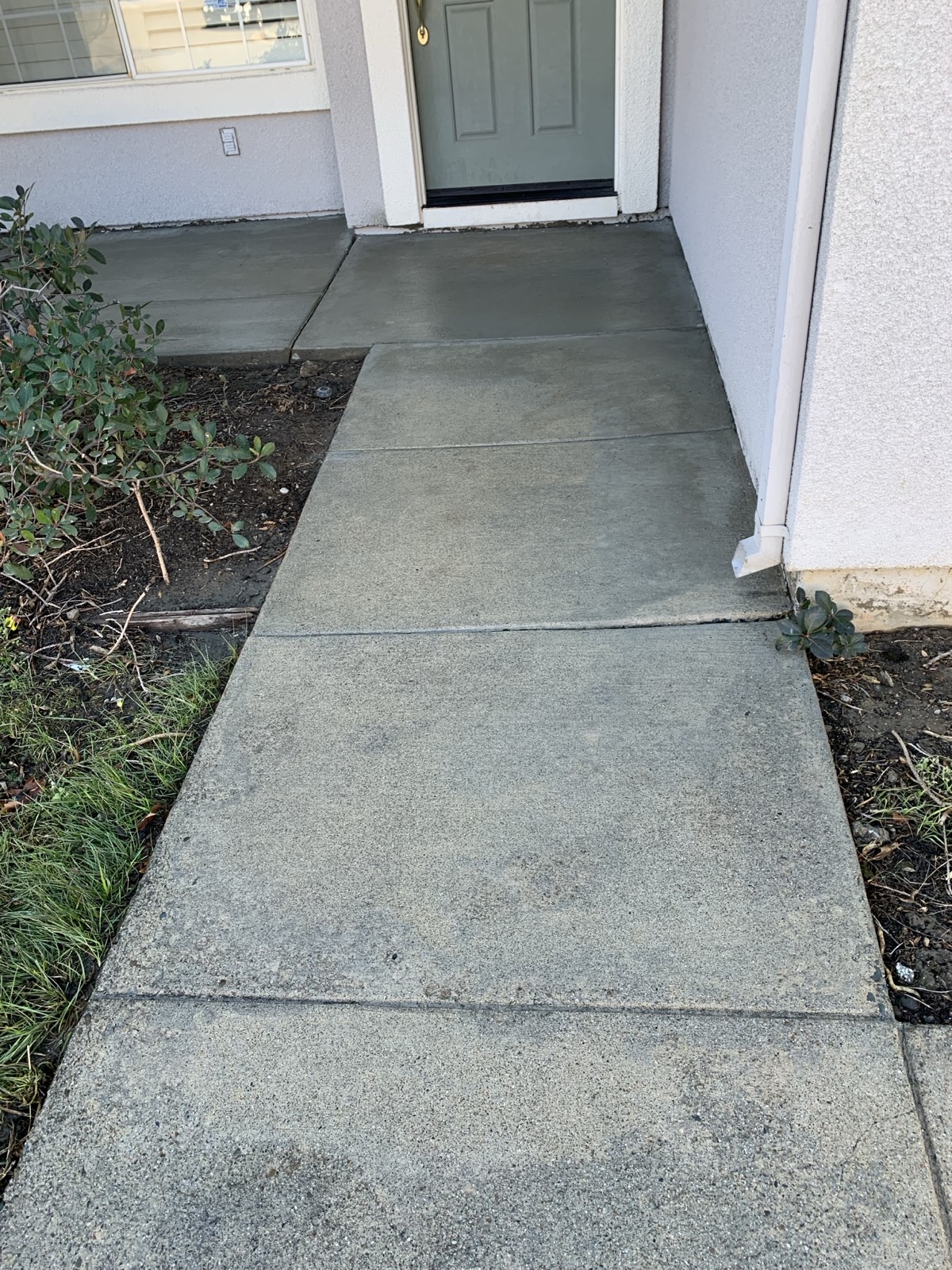 After — entry walkway to the front door of the Fremont home, cleaned and still damp