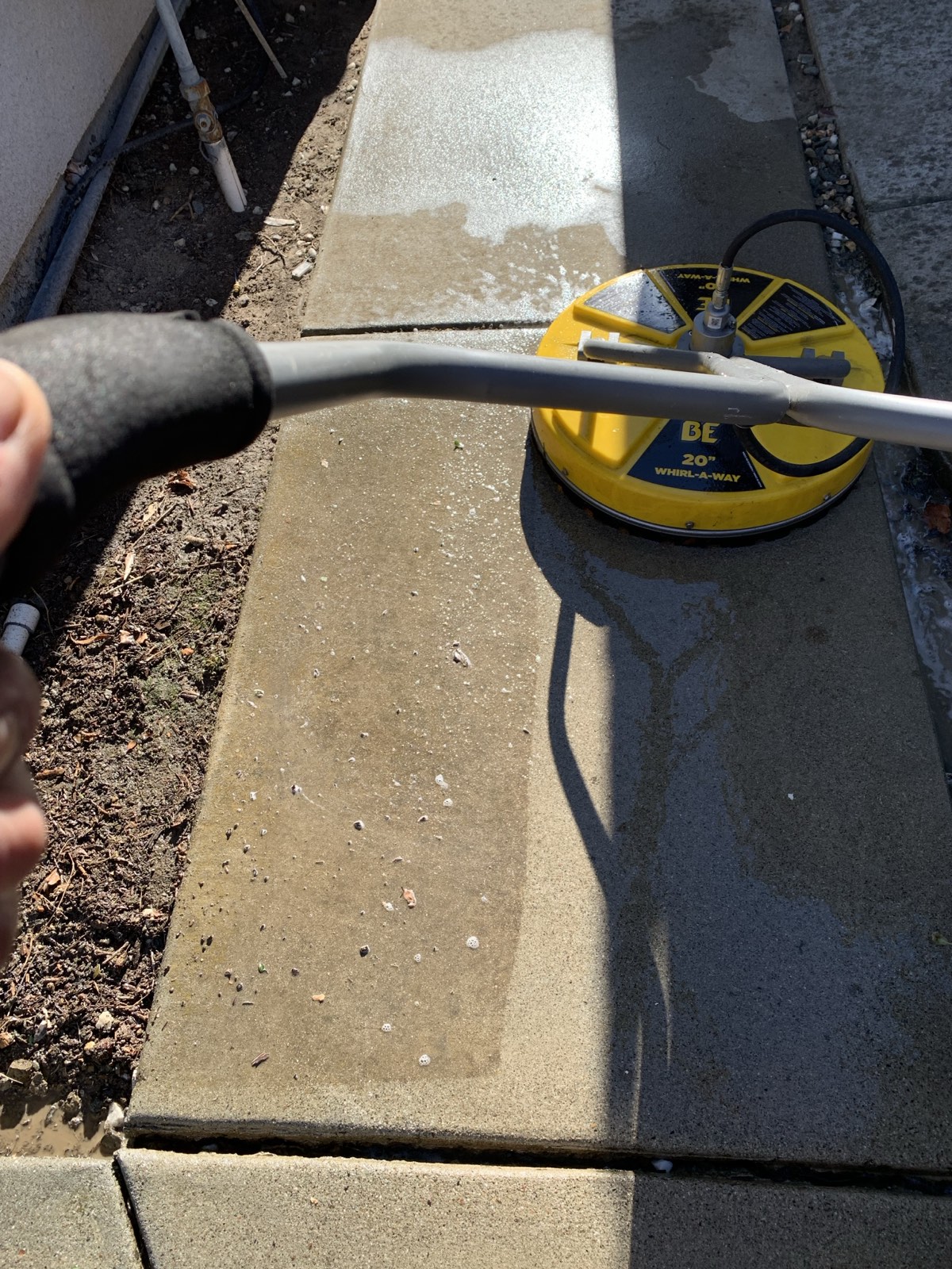 Mid-clean — 20 inch rotary surface cleaner lifting grime off the side walkway at the Fremont home