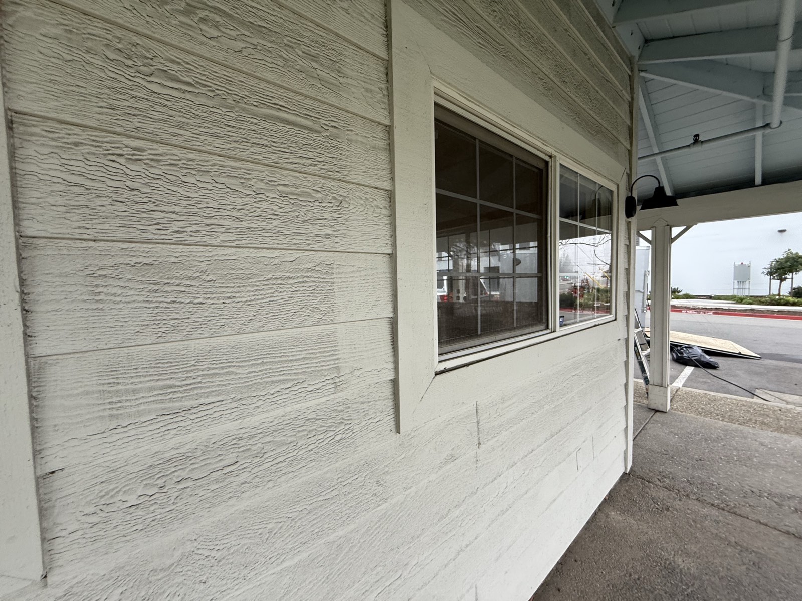 Before — Fremont building exterior showing pollution film on siding
