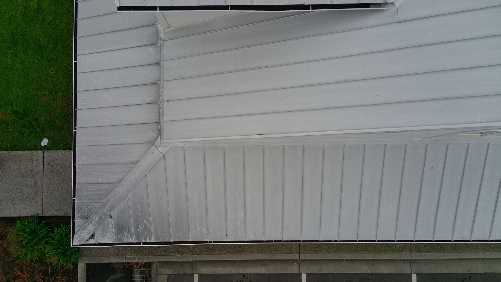 Before — Fremont standing seam metal roof oxidation streaking along seams
