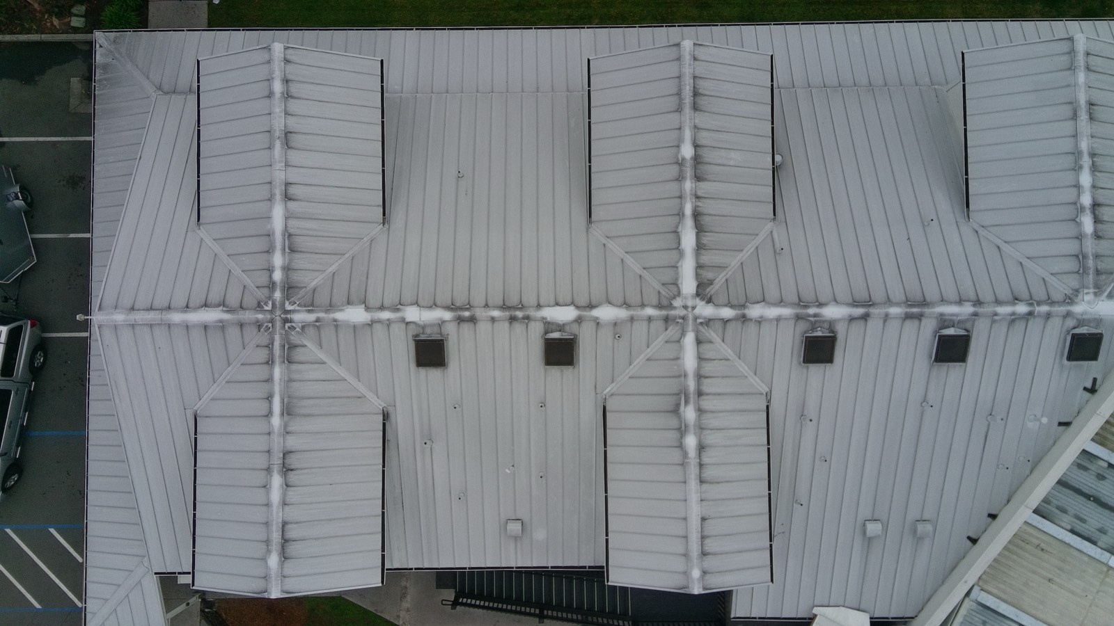 Before — Fremont metal roof and building facade before exterior cleaning