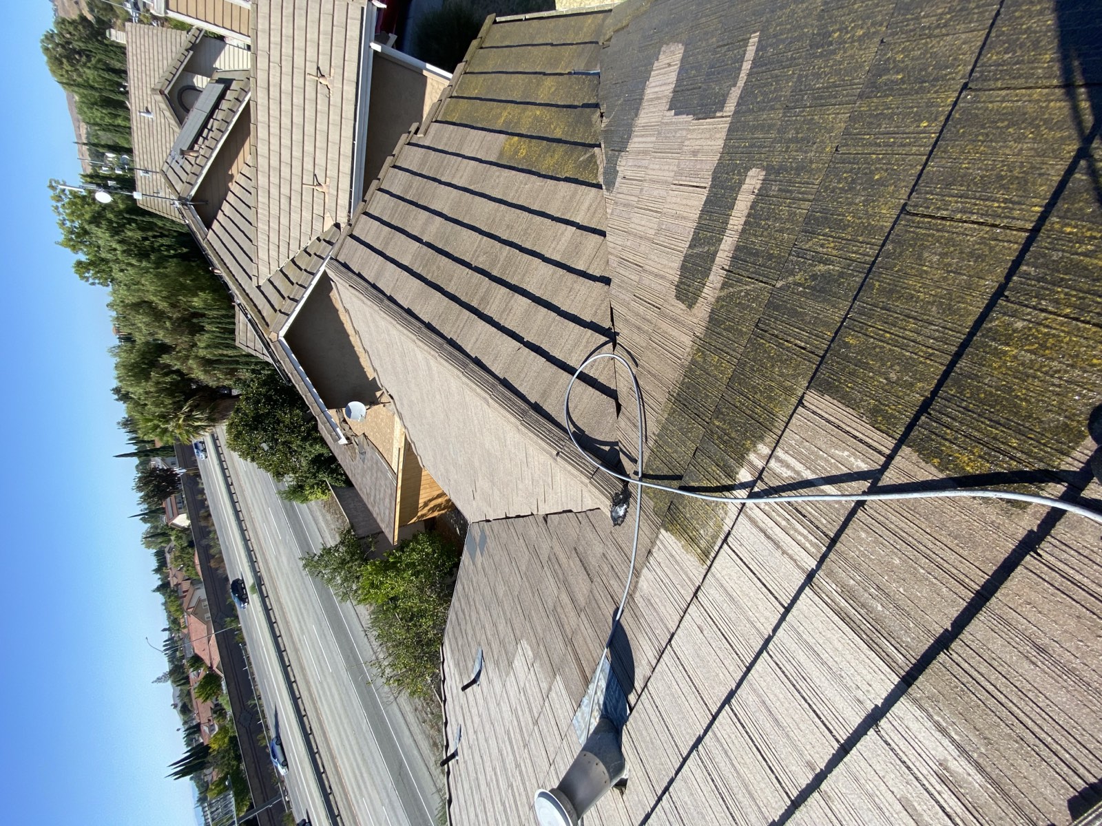Before — Fremont flat tile roof showing moss and organic buildup