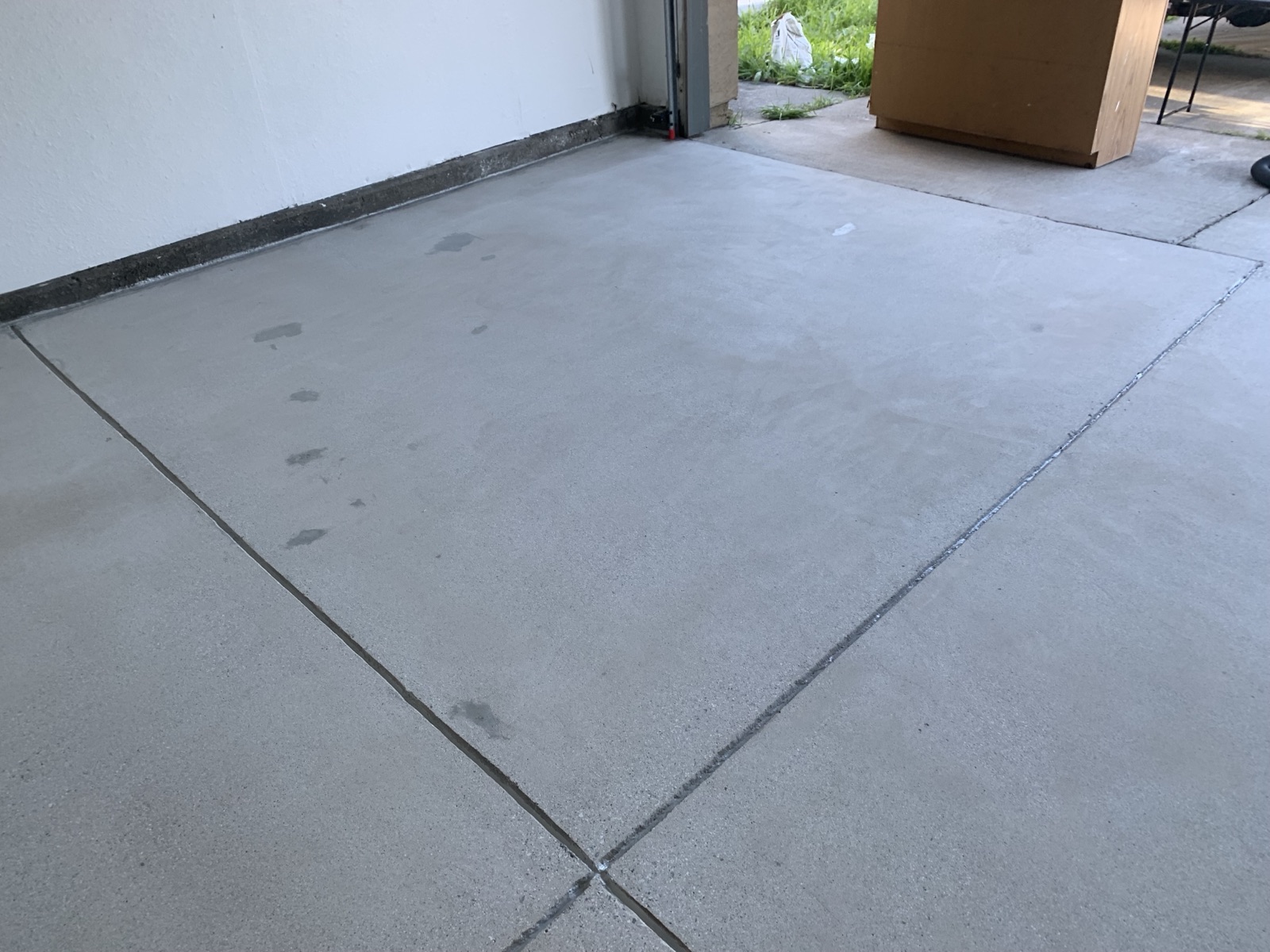 Before — unfinished Fremont garage concrete with stains and control joints before coating