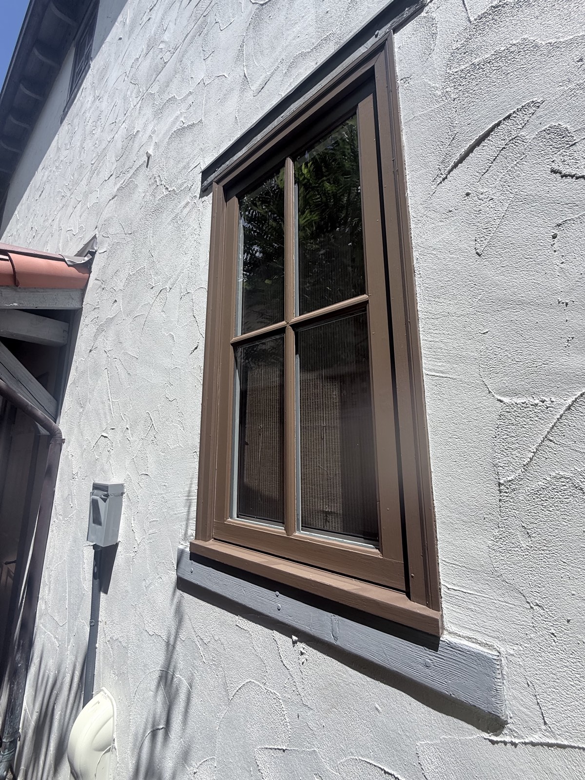 After — brown four-pane window on the Los Gatos home fully cleaned, webs and dust gone from frame and sill