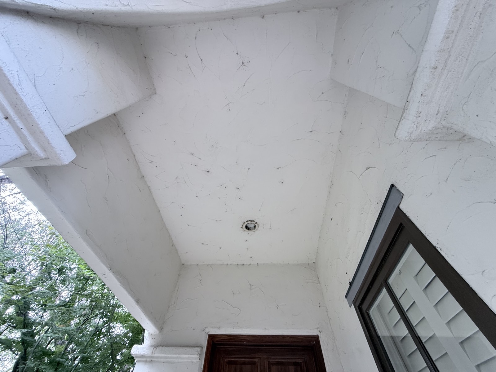 Before — porch ceiling of the Los Gatos home flecked with cobwebs and insect debris around the recessed light