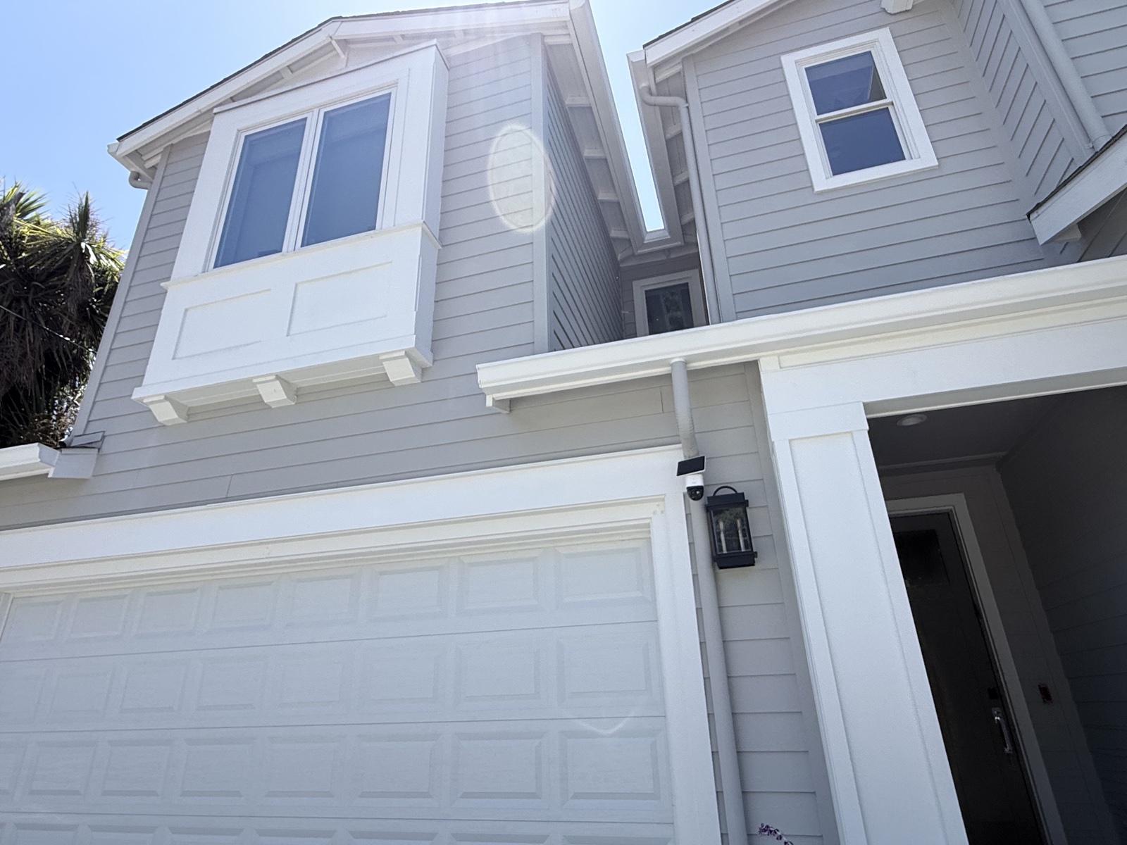 After — front of the Menlo Park home clean around the garage and entry, siding and white trim washed