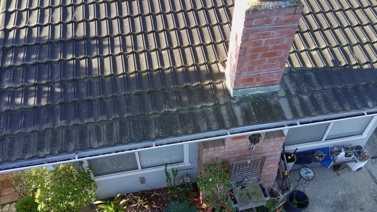 Before — Monte Sereno tile roof covered in organic growth before soft wash