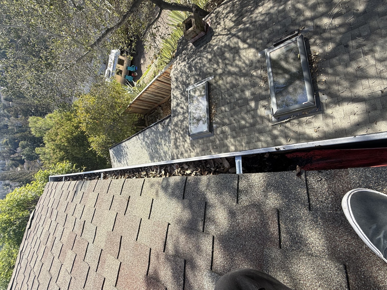 Before — San Mateo gutter with downspout inlet blocked by debris